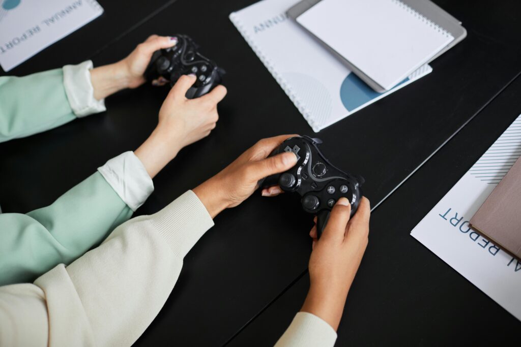 Two people playing video games with controllers, highlighting teamwork and gaming experience.